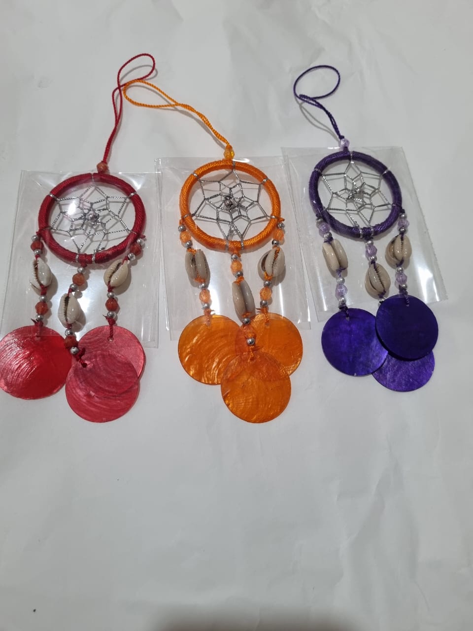 Colorful mini dreamcatcher keychain with natural shells and nylon webbing — perfect for car or wall hanging