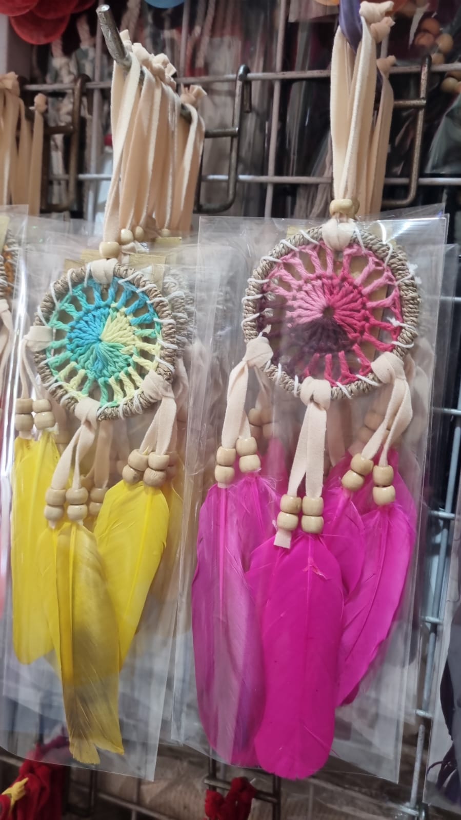 Small handmade agel dreamcatcher 6cm with natural wood beads and colorful feathers.
