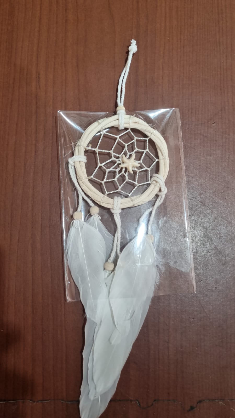 Small handmade rattan dreamcatcher 6 cm with white feathers, ideal for boho home or car decoration.