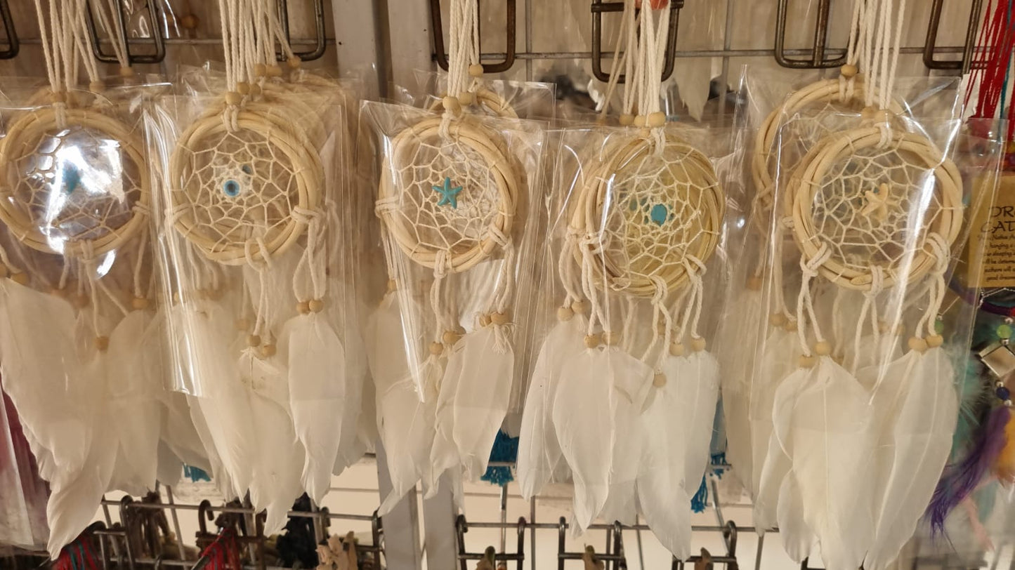 Small handmade rattan dreamcatcher 6 cm with white feathers, ideal for boho home or car decoration.