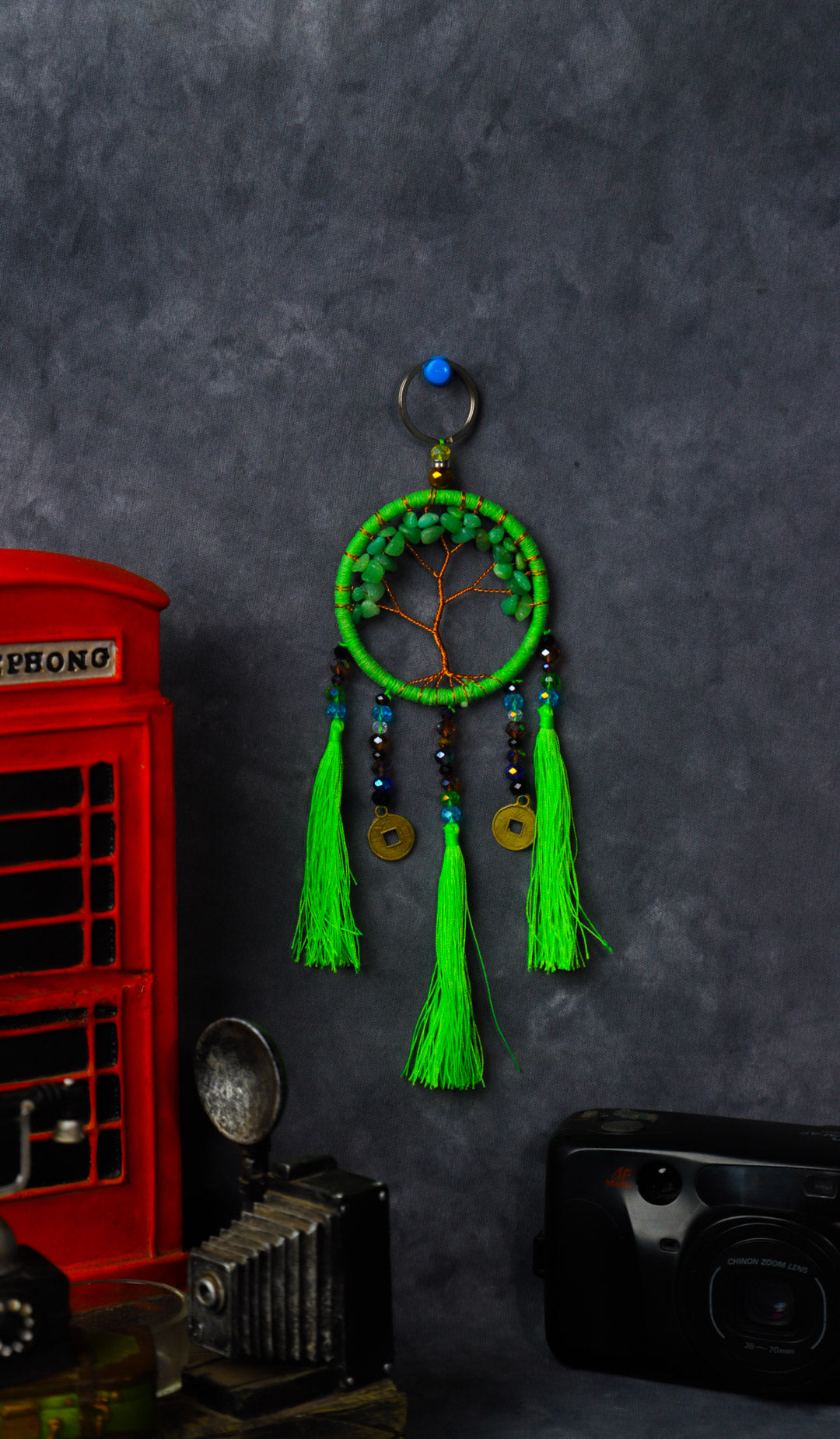 Turquoise-wrapped Tree of Life dreamcatcher keychain with green stone leaves and teal tassels.