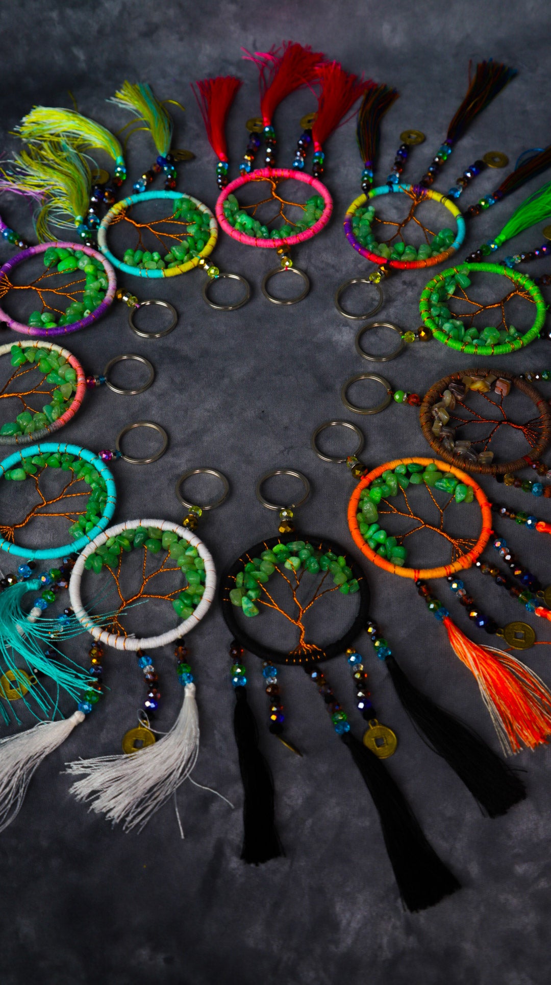 Turquoise-wrapped Tree of Life dreamcatcher keychain with green stone leaves and teal tassels.