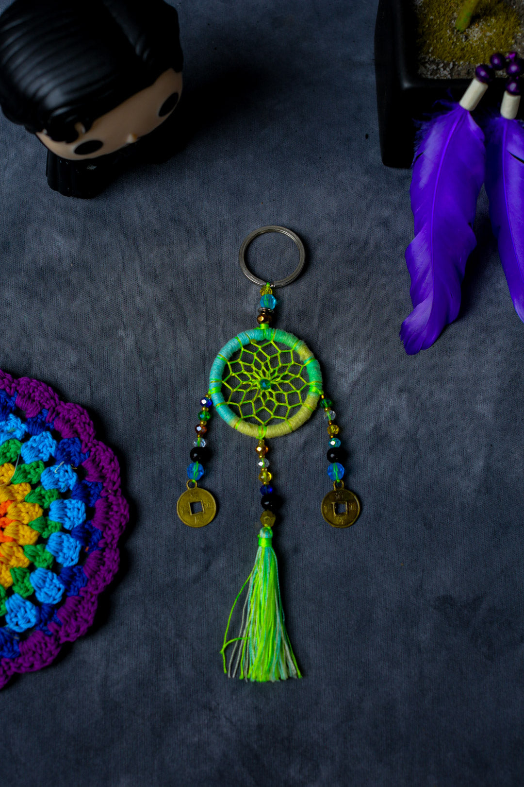 Hand-woven Green dreamcatcher keychain with tassel, beads, and lucky coins.