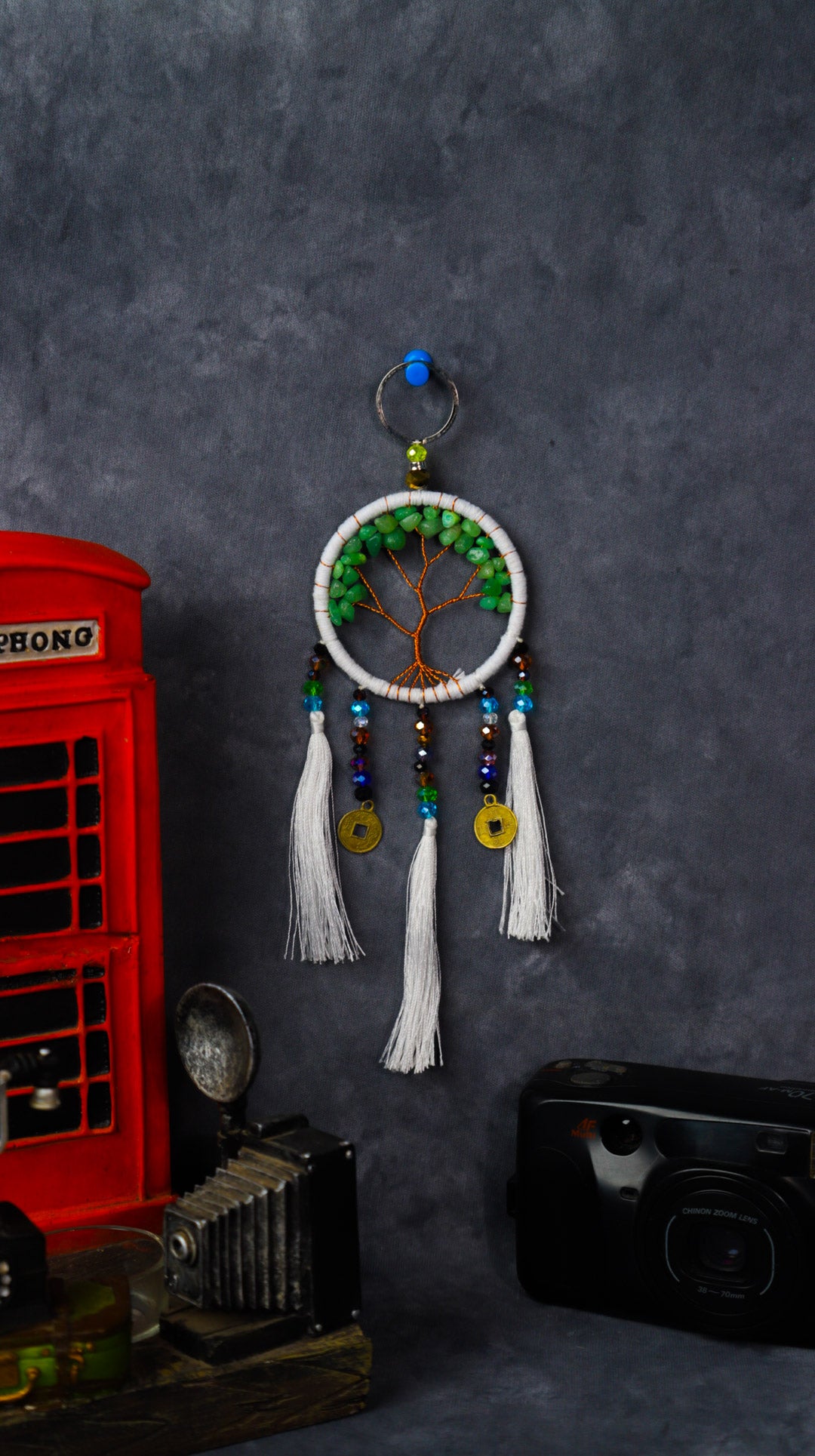 Turquoise-wrapped Tree of Life dreamcatcher keychain with green stone leaves and teal tassels.