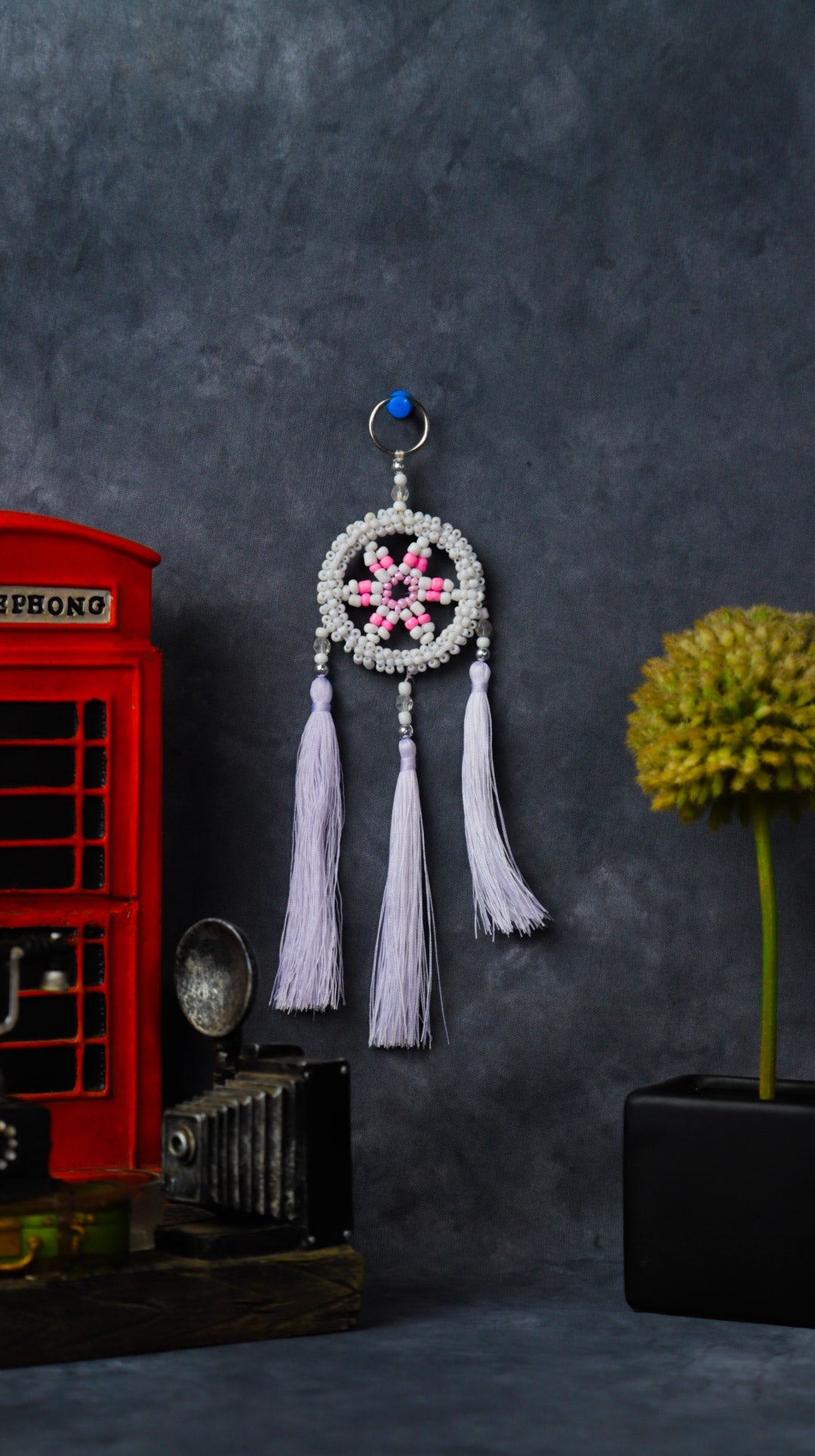 Turquoise beaded dreamcatcher keychain with triple tassels hanging on split ring.