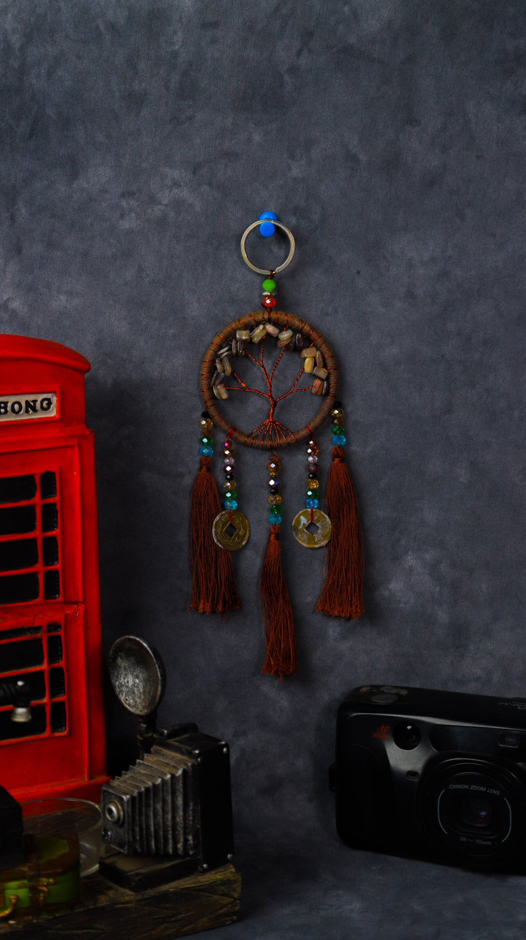 Turquoise-wrapped Tree of Life dreamcatcher keychain with green stone leaves and teal tassels.