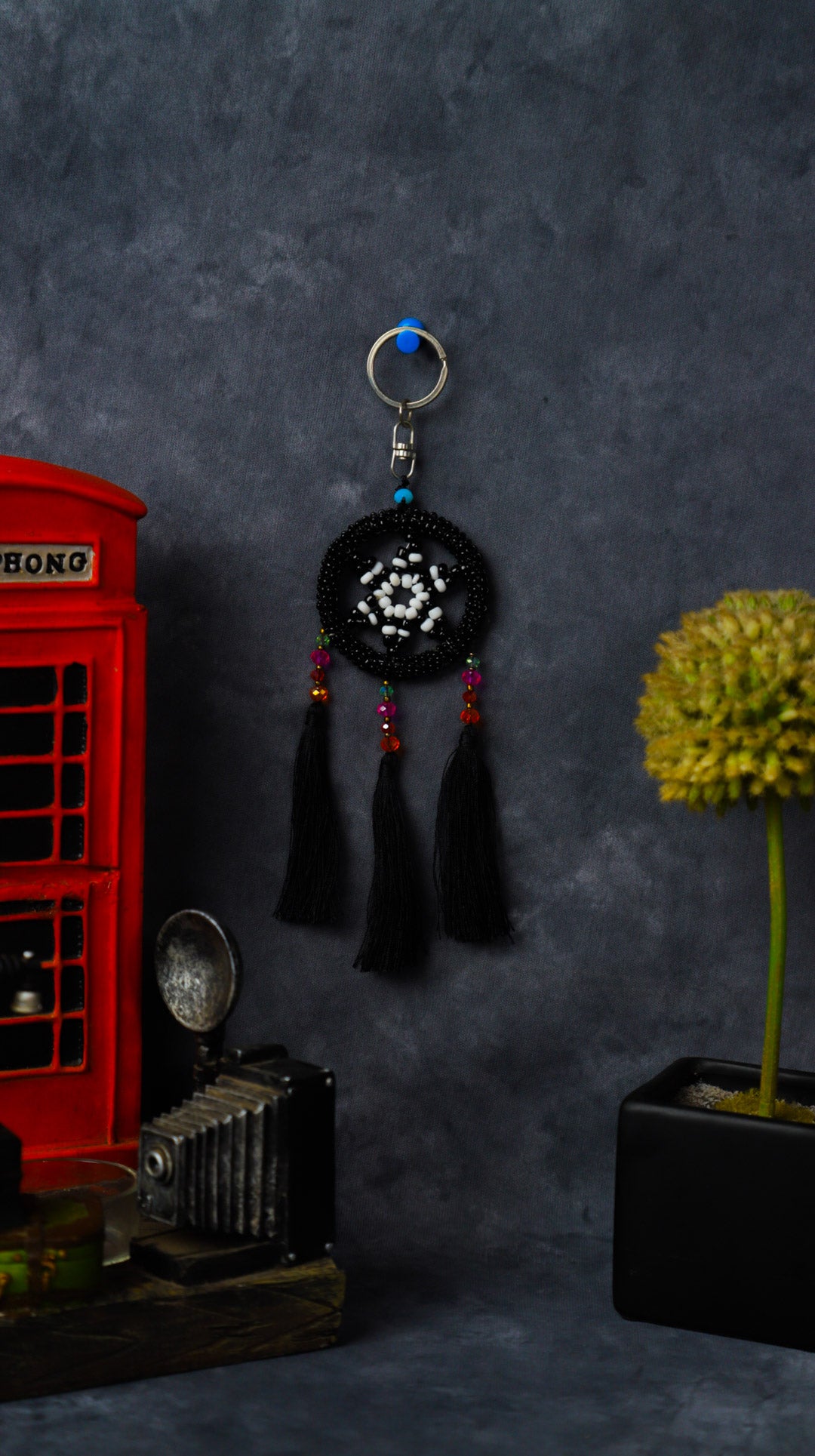 Turquoise beaded dreamcatcher keychain with triple tassels hanging on split ring.