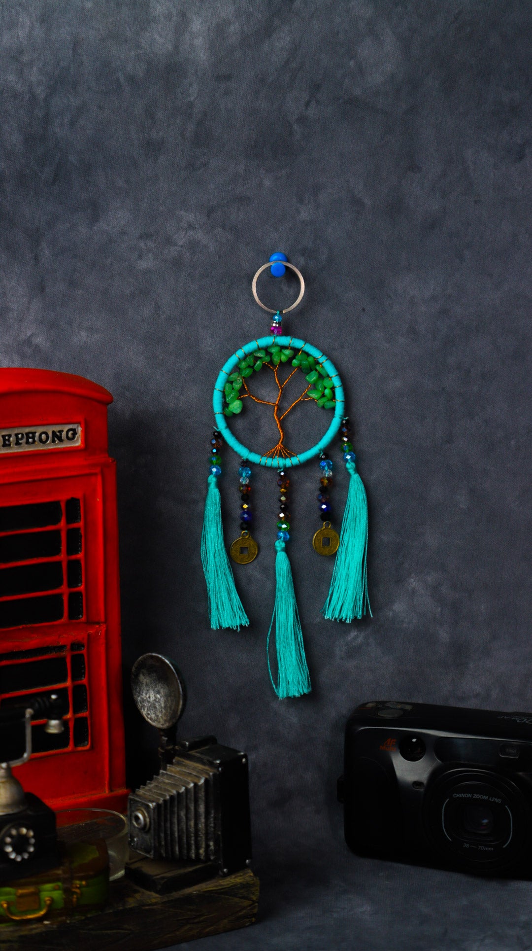 Turquoise-wrapped Tree of Life dreamcatcher keychain with green stone leaves and teal tassels.