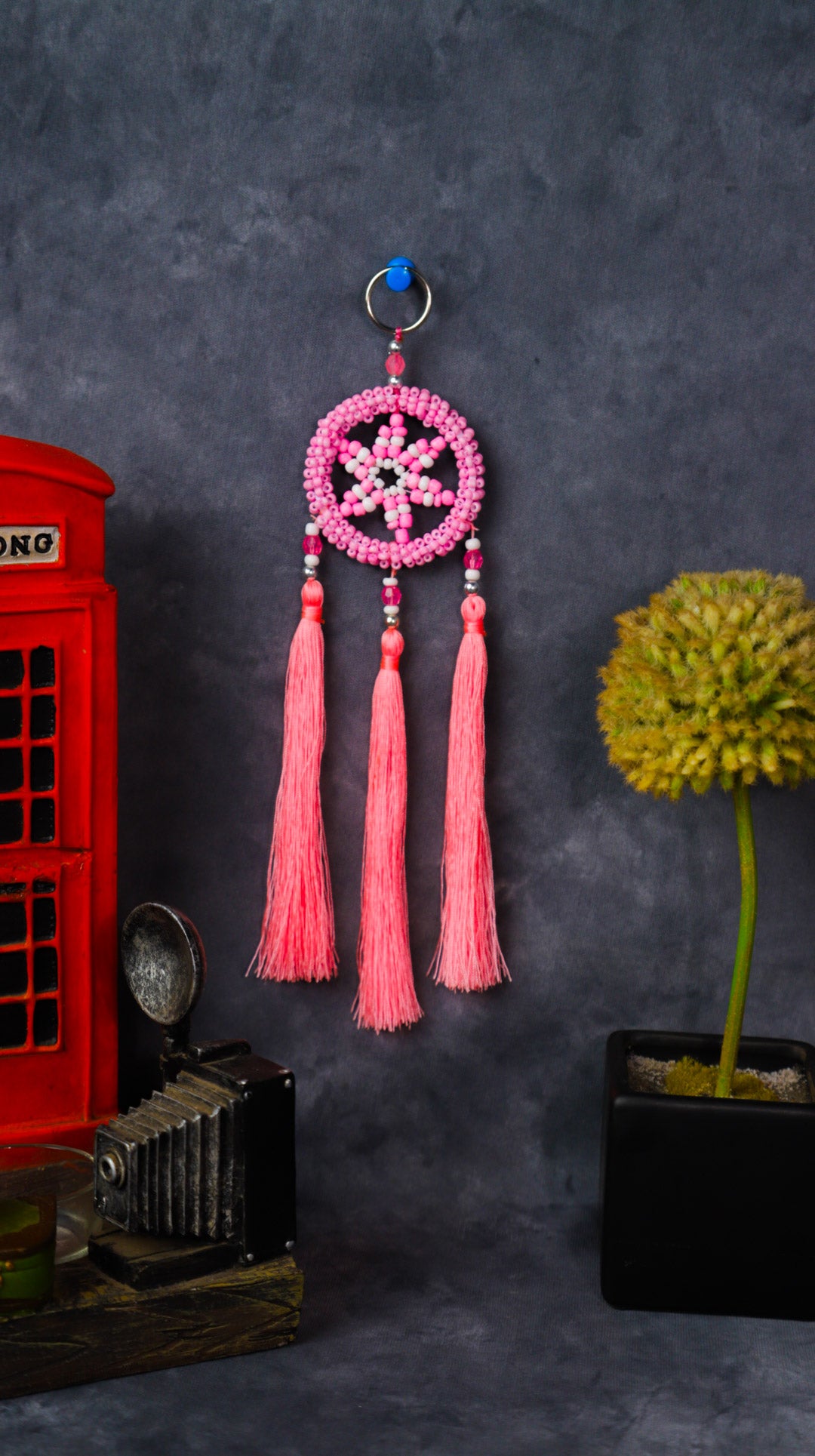 Turquoise beaded dreamcatcher keychain with triple tassels hanging on split ring.