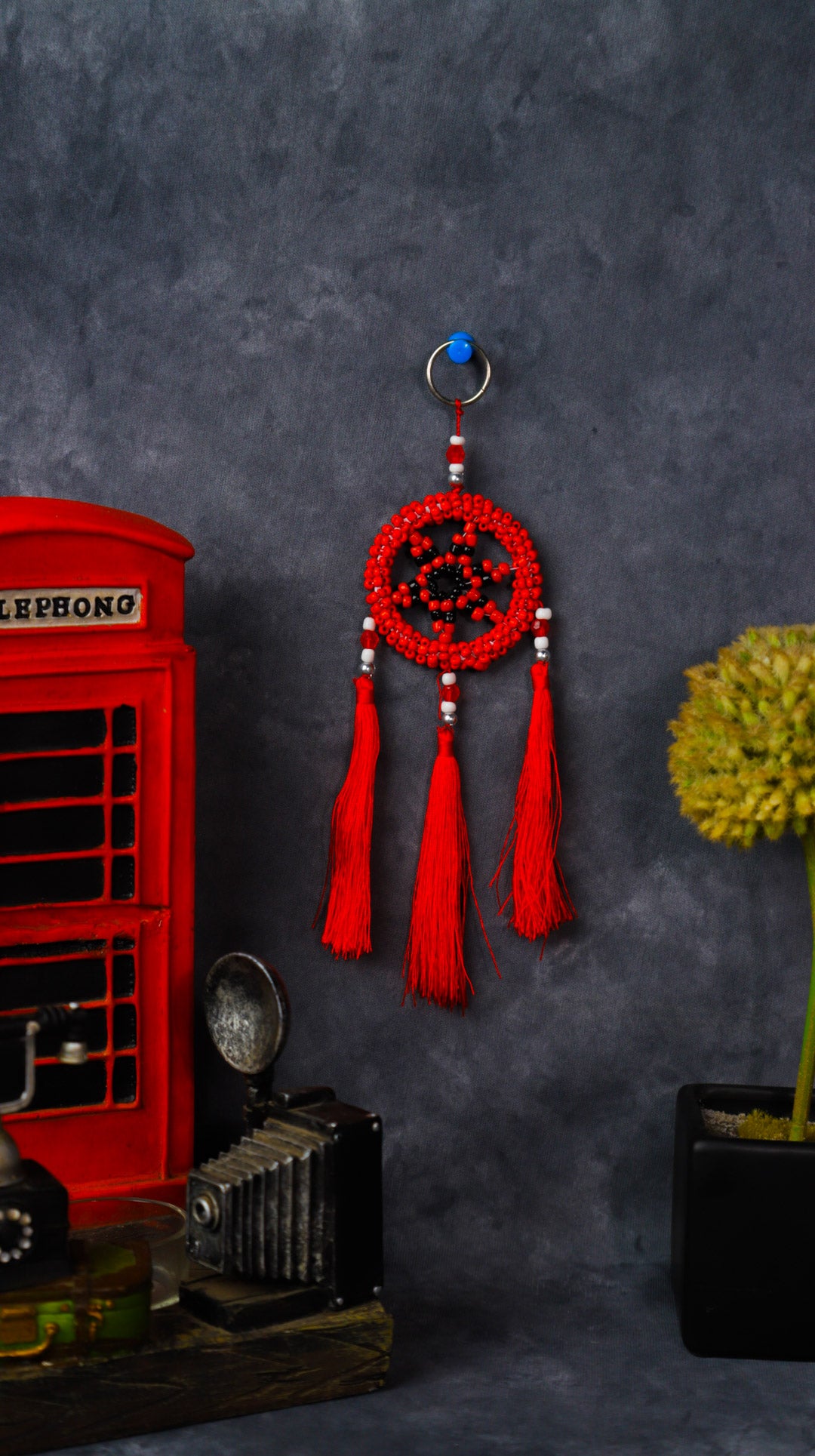 Turquoise beaded dreamcatcher keychain with triple tassels hanging on split ring.