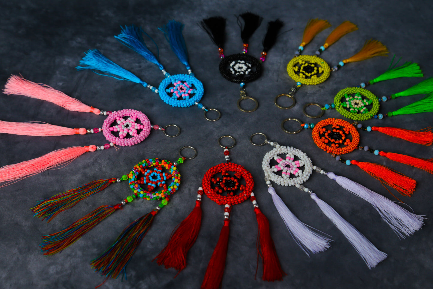 Turquoise beaded dreamcatcher keychain with triple tassels hanging on split ring.