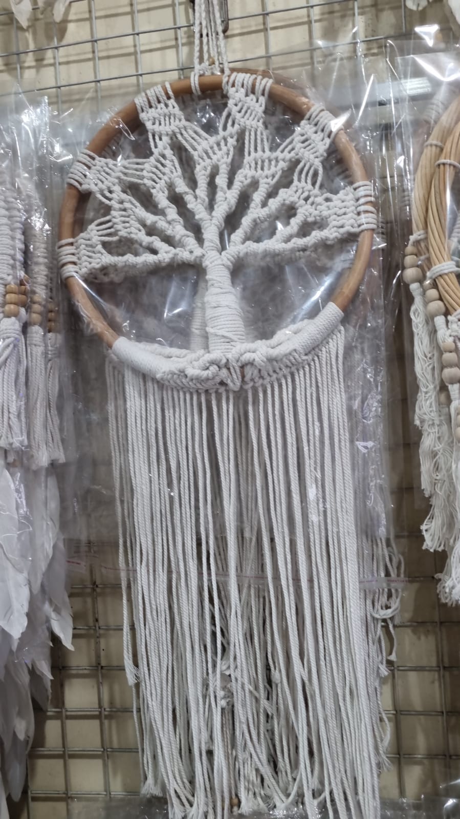 Handmade Tree of Life dreamcatcher made with macrame cotton rope and a rattan ring, featuring minimalist fringe for boho and spiritual interiors.