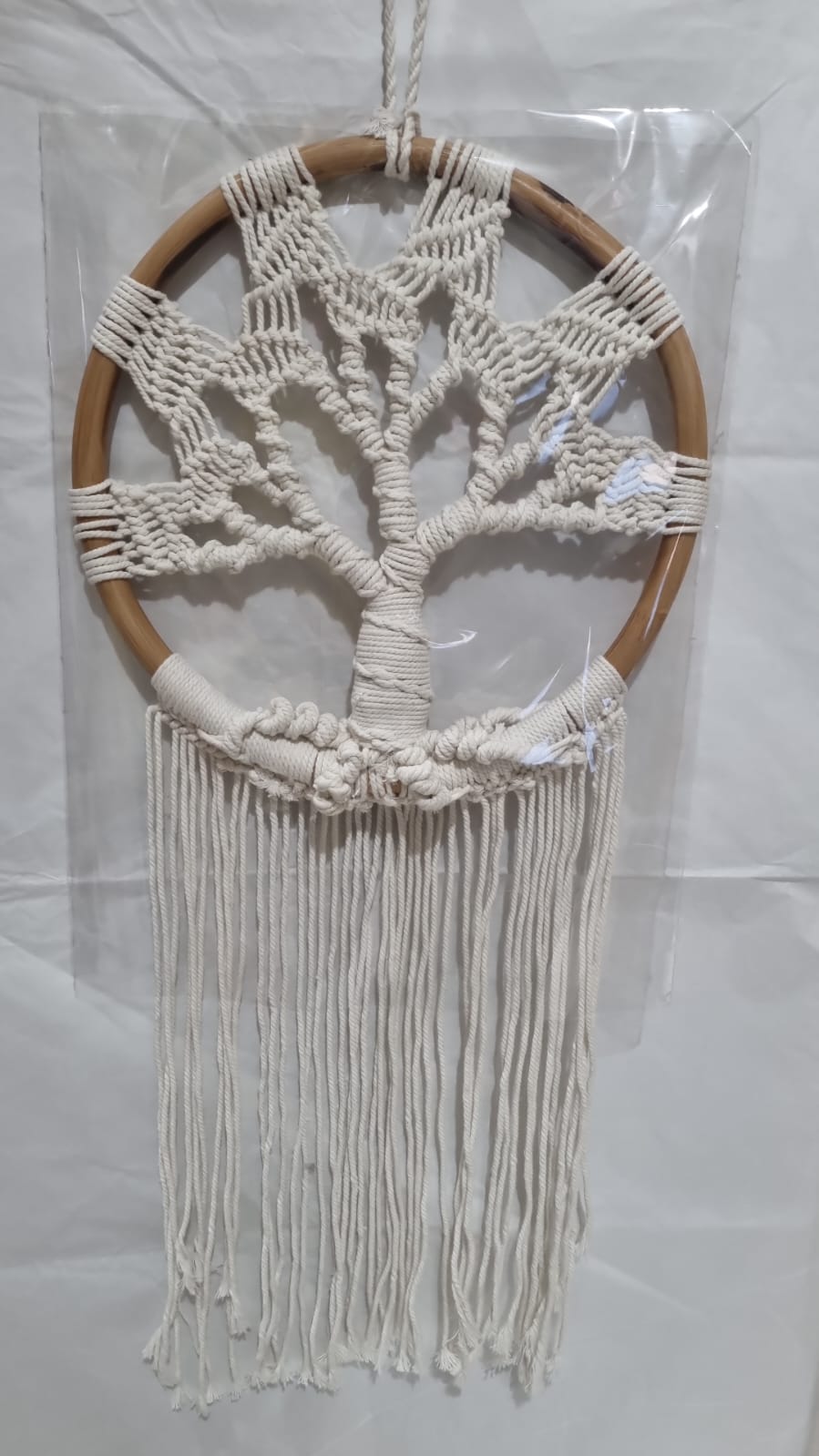 Handmade Tree of Life dreamcatcher made with macrame cotton rope and a rattan ring, featuring minimalist fringe for boho and spiritual interiors.