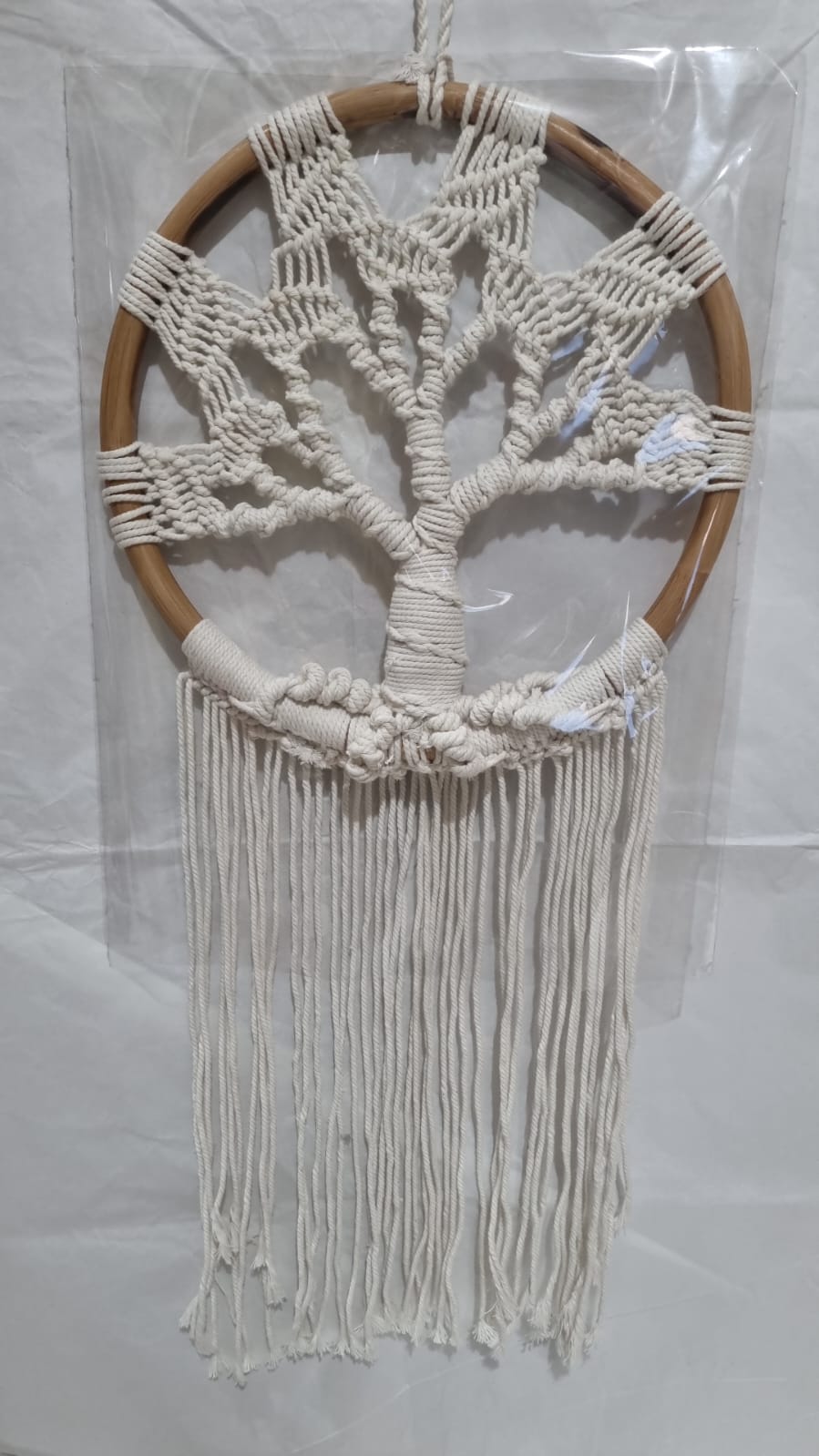 Handmade Tree of Life dreamcatcher made with macrame cotton rope and a rattan ring, featuring minimalist fringe for boho and spiritual interiors.