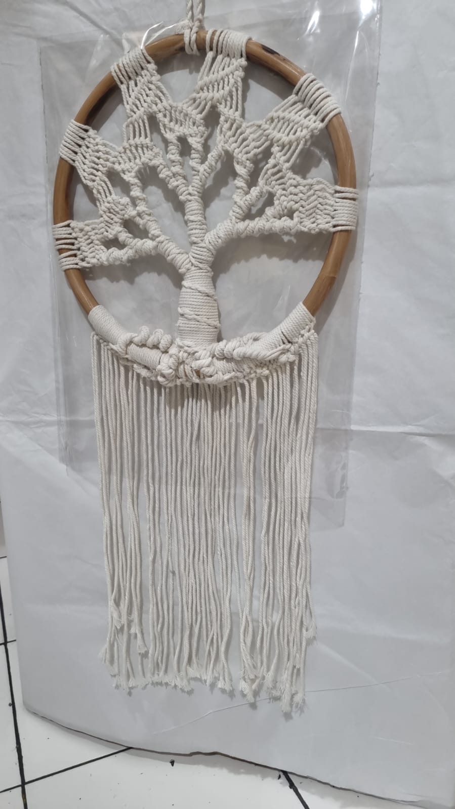 Handmade Tree of Life dreamcatcher made with macrame cotton rope and a rattan ring, featuring minimalist fringe for boho and spiritual interiors.