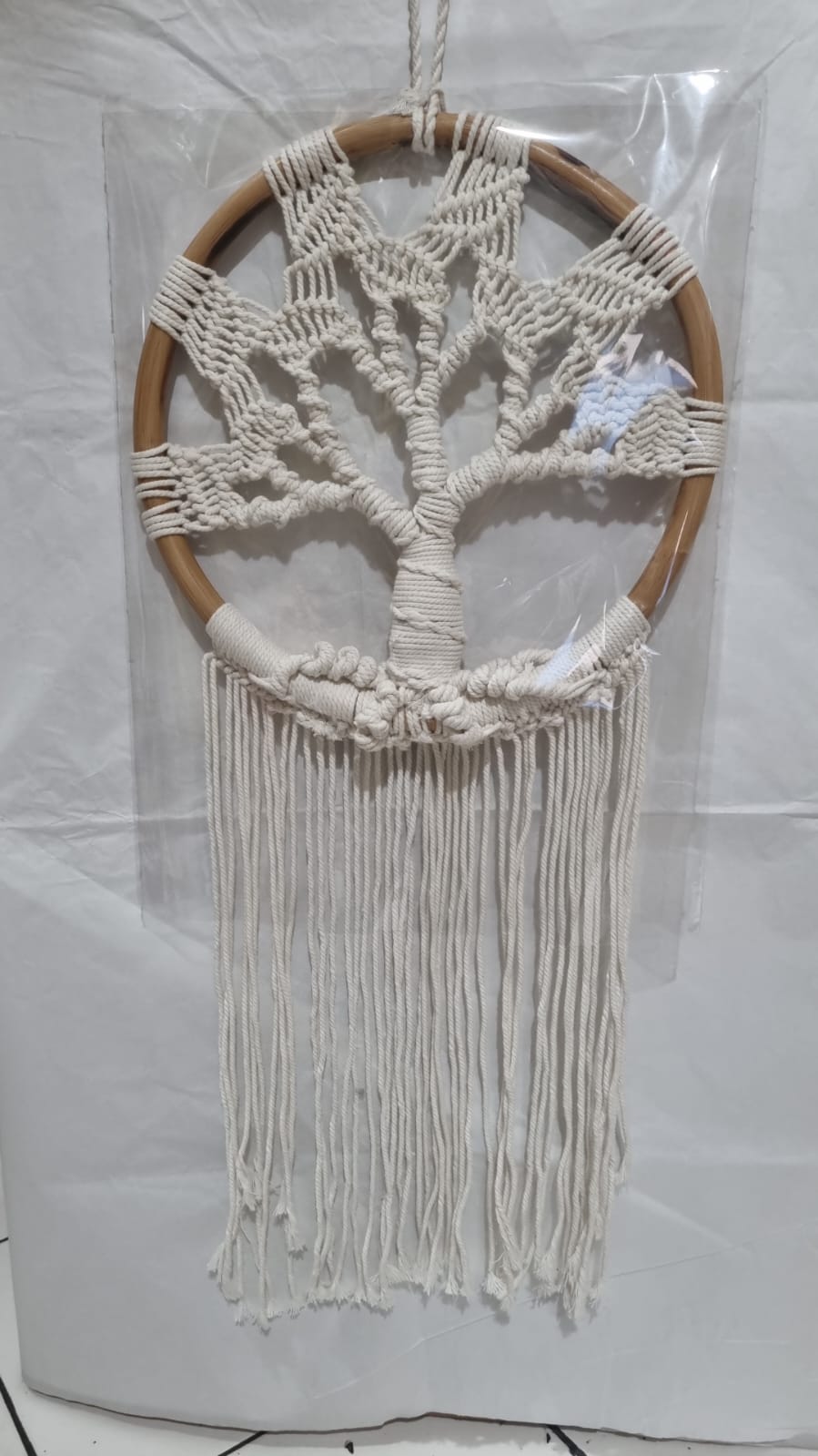 Handmade Tree of Life dreamcatcher made with macrame cotton rope and a rattan ring, featuring minimalist fringe for boho and spiritual interiors.