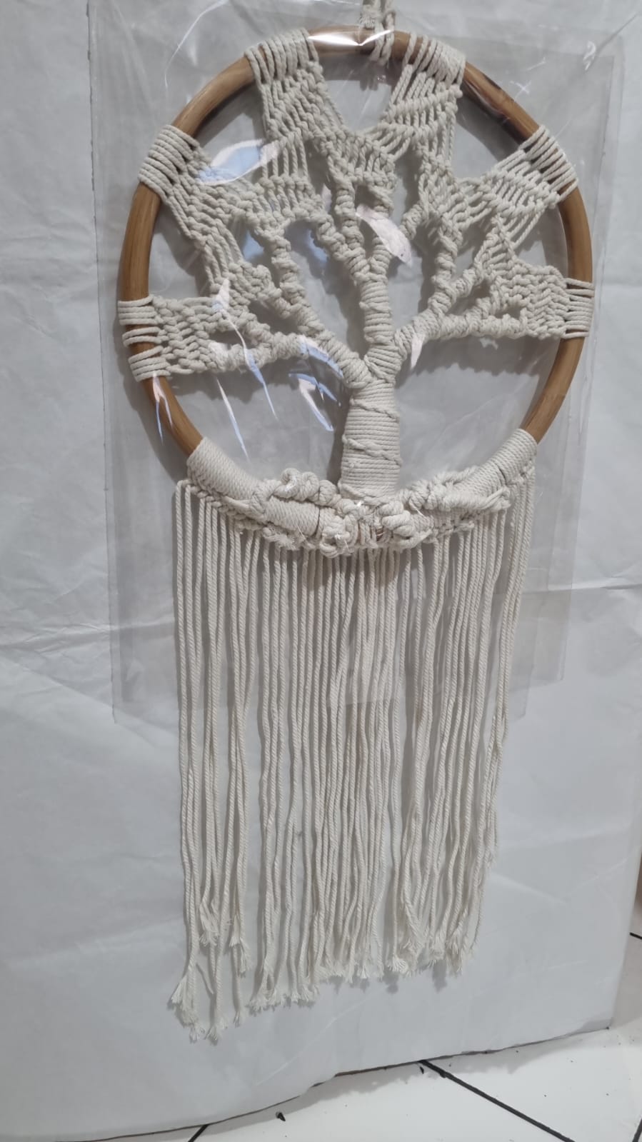 Handmade Tree of Life dreamcatcher made with macrame cotton rope and a rattan ring, featuring minimalist fringe for boho and spiritual interiors.