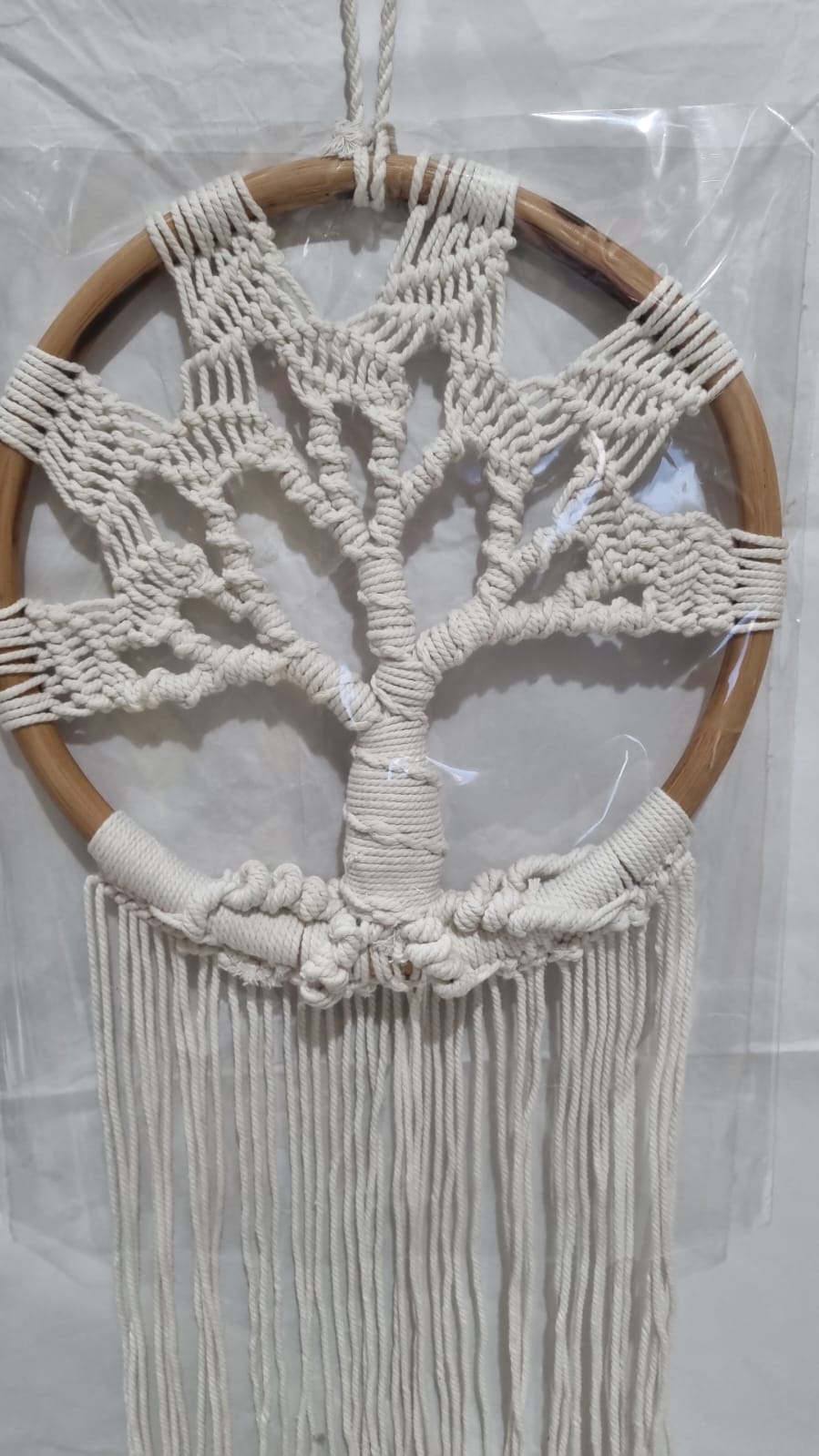 Handmade Tree of Life dreamcatcher made with macrame cotton rope and a rattan ring, featuring minimalist fringe for boho and spiritual interiors.