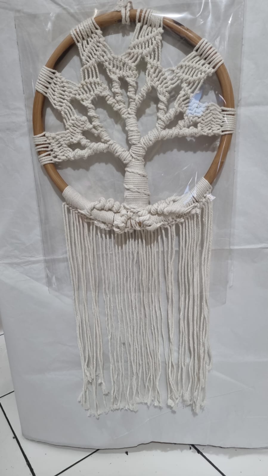 Handmade Tree of Life dreamcatcher made with macrame cotton rope and a rattan ring, featuring minimalist fringe for boho and spiritual interiors.
