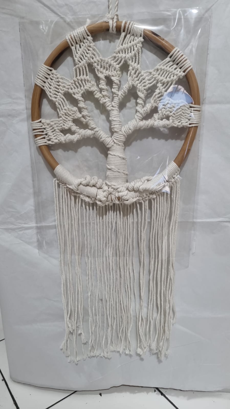 Handmade Tree of Life dreamcatcher made with macrame cotton rope and a rattan ring, featuring minimalist fringe for boho and spiritual interiors.