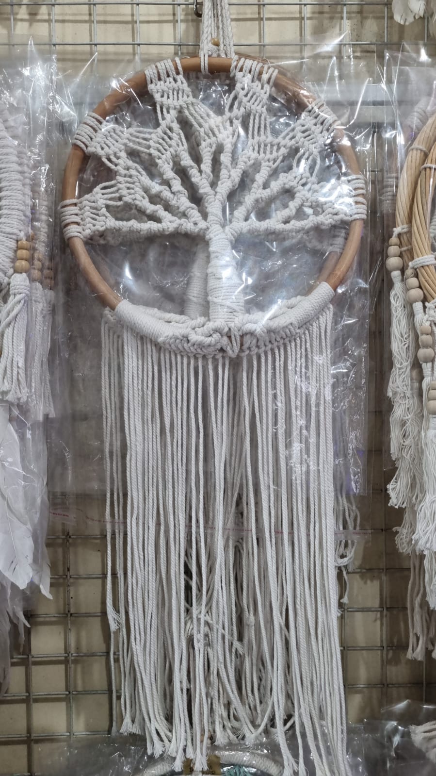 Handmade Tree of Life dreamcatcher made with macrame cotton rope and a rattan ring, featuring minimalist fringe for boho and spiritual interiors.