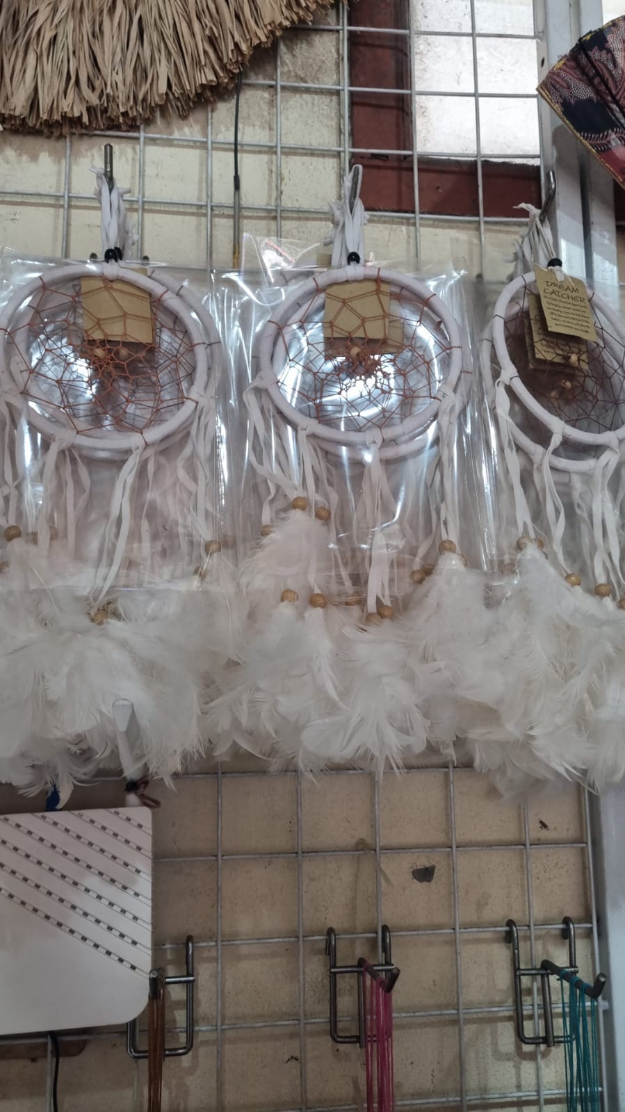 12cm handmade suede dreamcatcher with white feathers and wood beads – perfect for home décor or wholesale gifts.