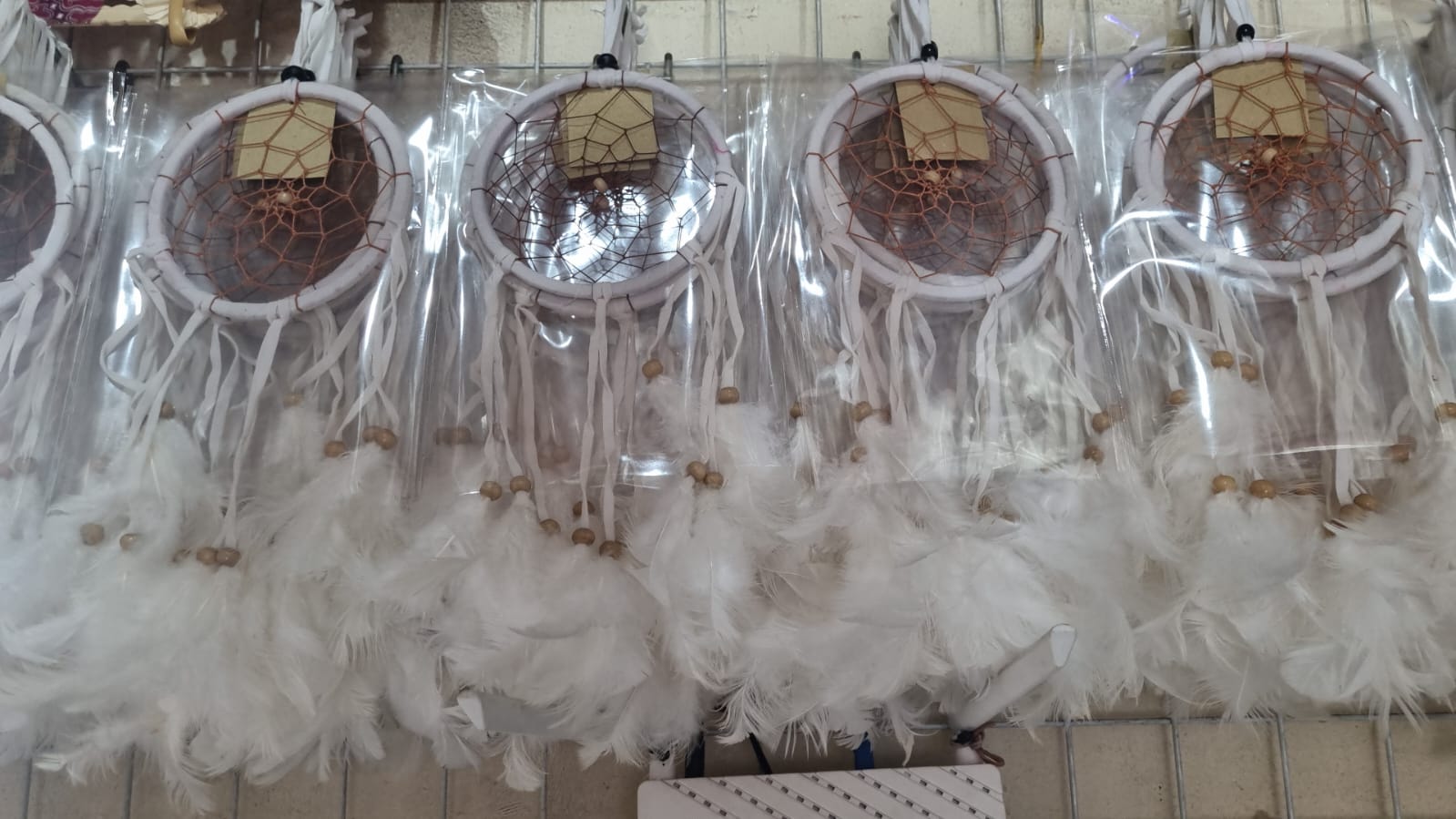 12cm handmade suede dreamcatcher with white feathers and wood beads – perfect for home décor or wholesale gifts.