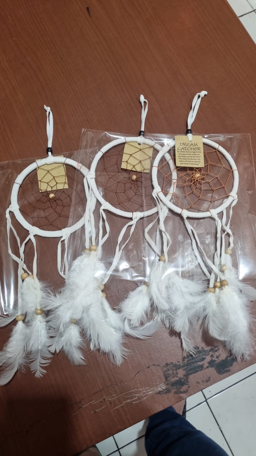 12cm handmade suede dreamcatcher with white feathers and wood beads – perfect for home décor or wholesale gifts.