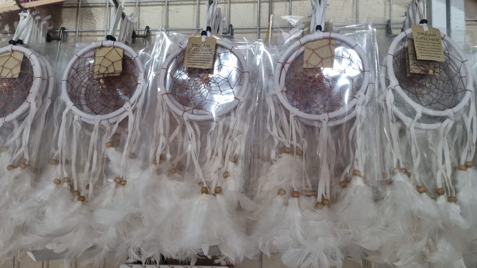 12cm handmade suede dreamcatcher with white feathers and wood beads – perfect for home décor or wholesale gifts.