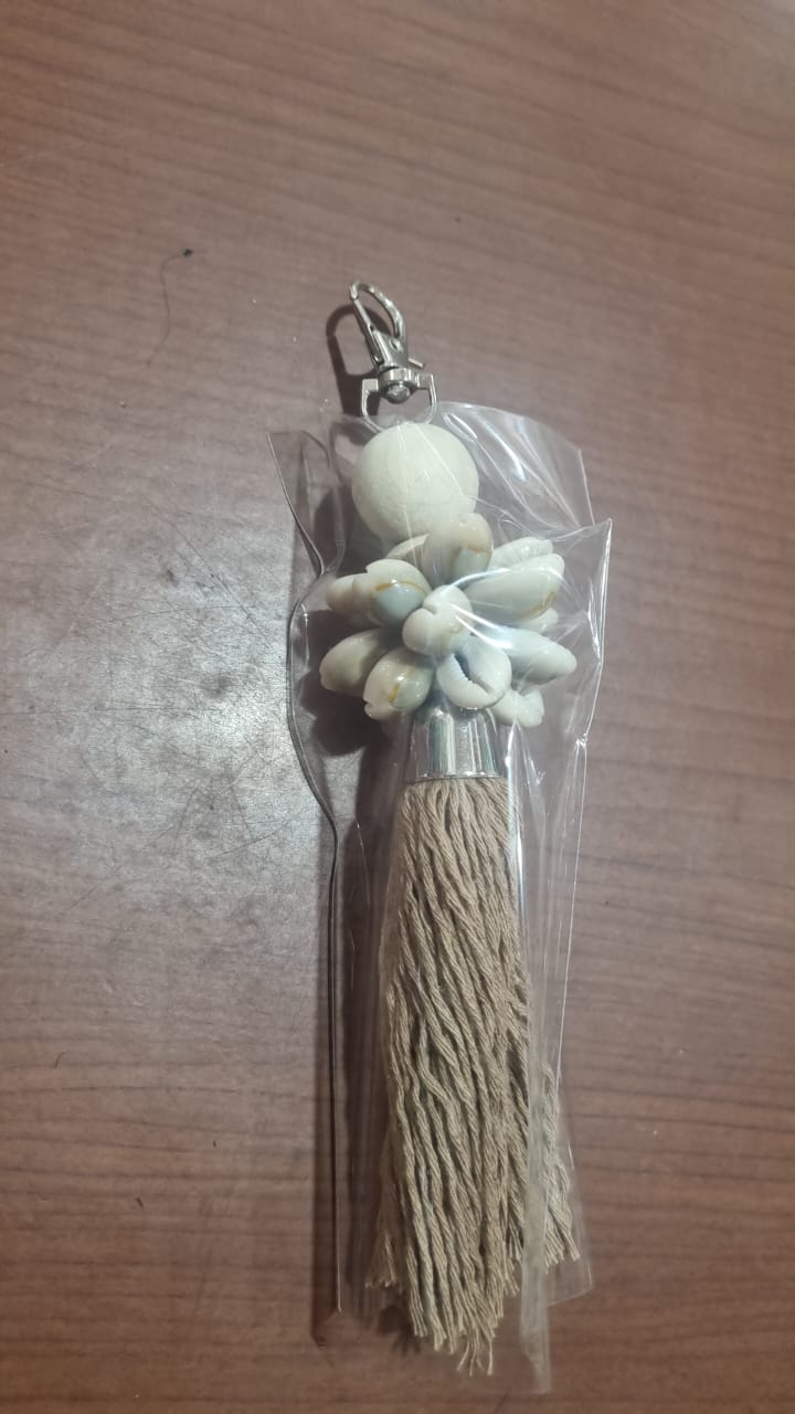 Handcrafted dreamcatcher keychain with wooden beads, shells, and colorful tassel