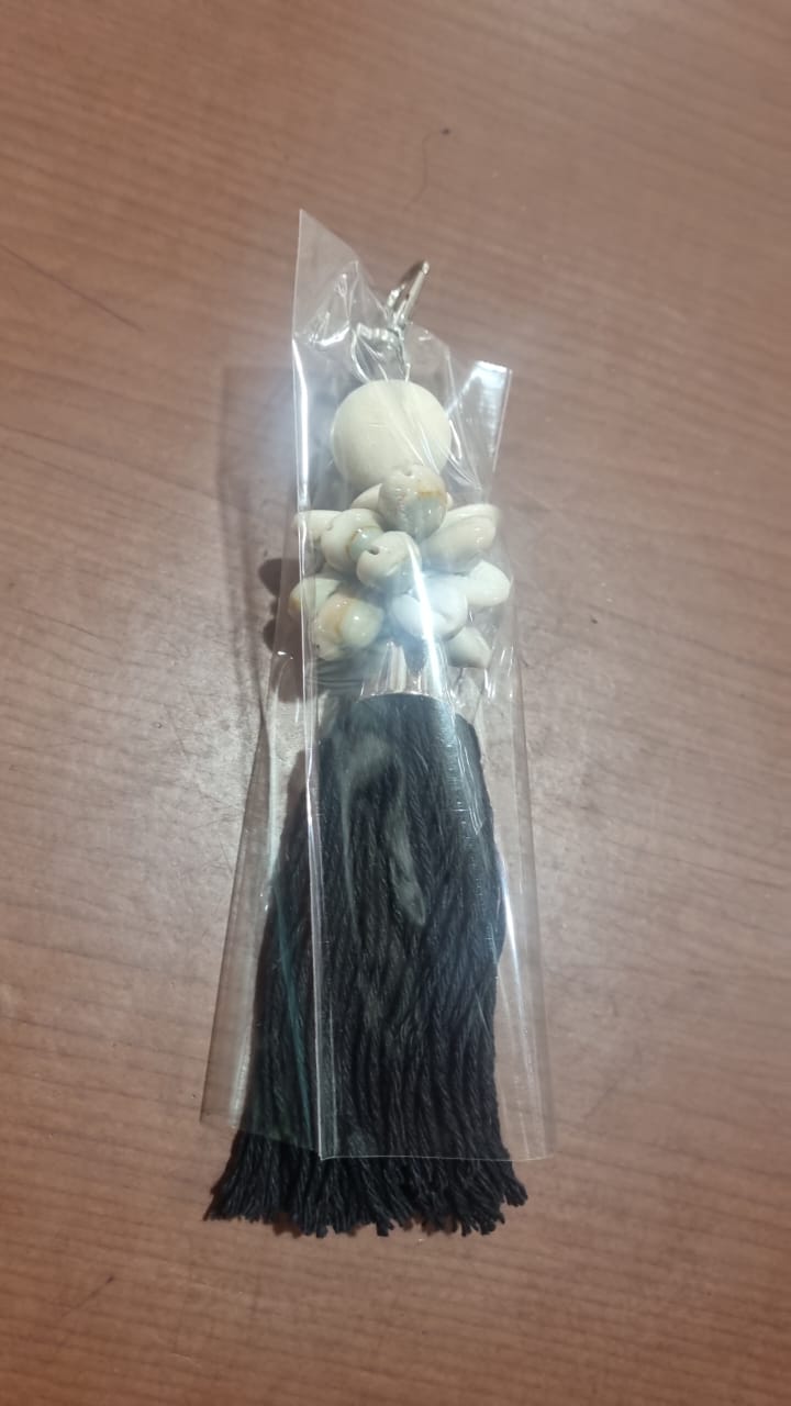 Handcrafted dreamcatcher keychain with wooden beads, shells, and colorful tassel