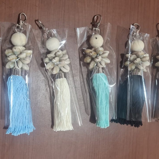 Handcrafted dreamcatcher keychain with wooden beads, shells, and colorful tassel