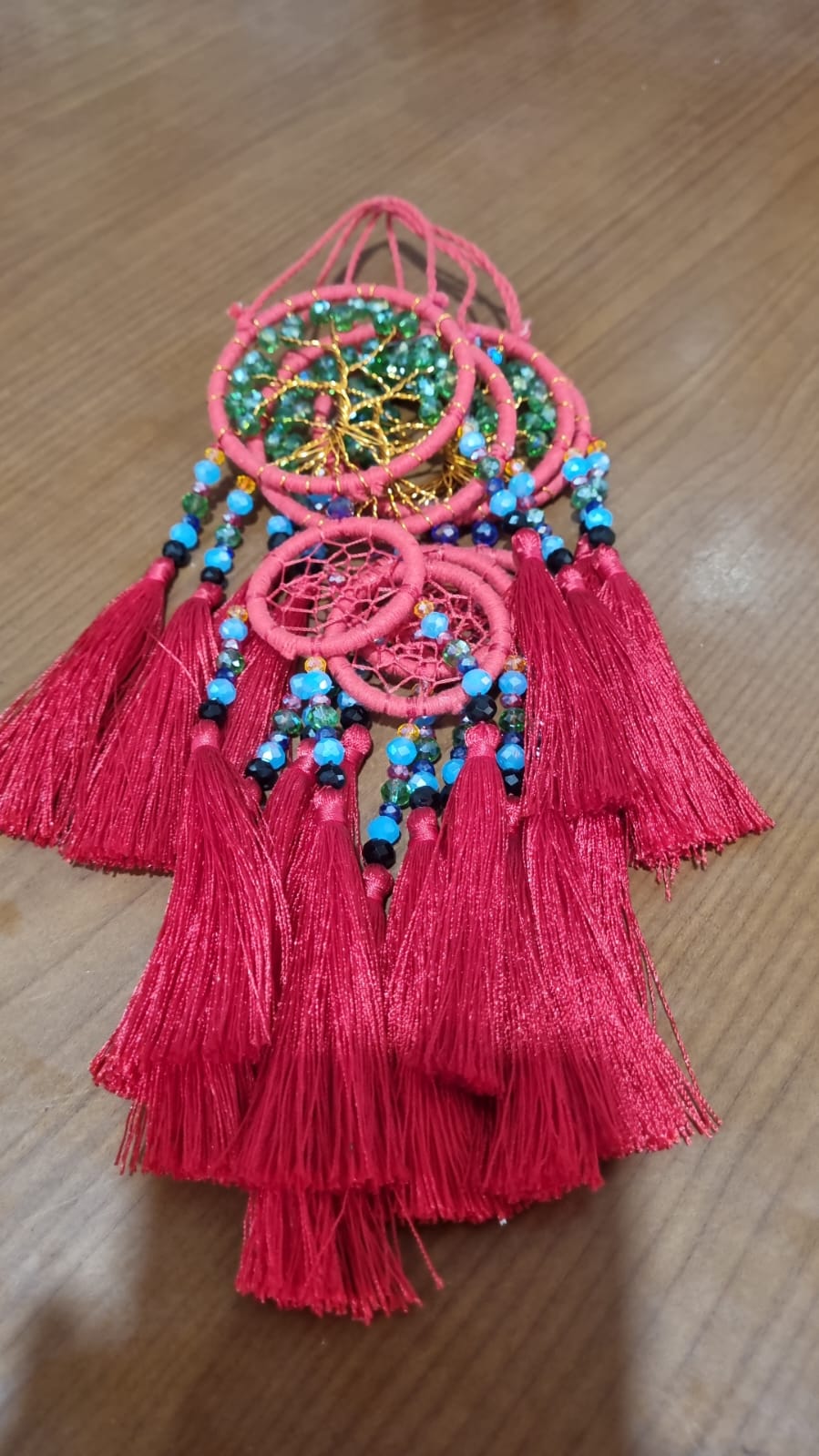 Handcrafted Tree of Life dreamcatcher 6cm with red tassels and crystal beads — boho home décor and gift item.