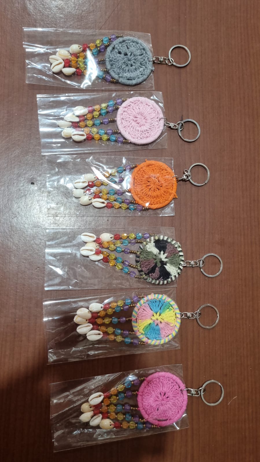 Mini dreamcatcher keychain handmade with cotton crochet, colorful beads, and shells