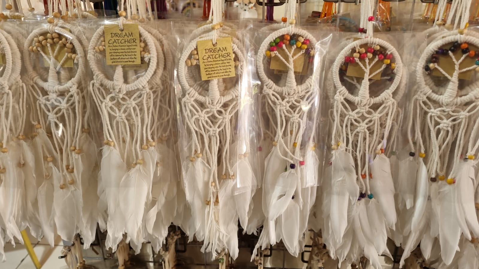 Mini handmade Tree of Life dreamcatcher with cotton cord, wooden beads, and white feathers – 7 cm (2.75 inch) wall hanging decor.