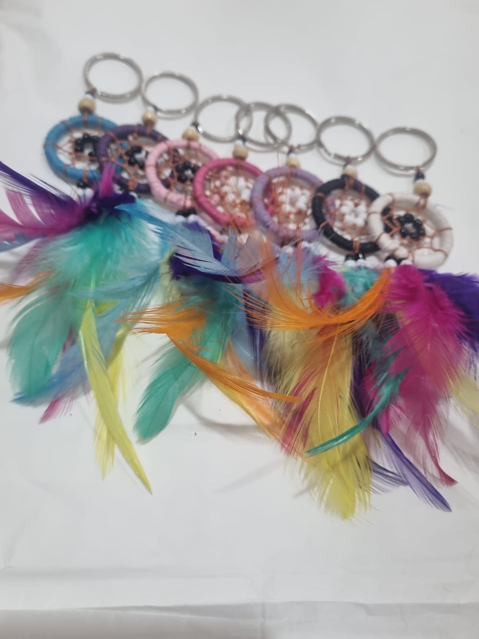 Handcrafted dreamcatcher keychain with colorful feathers and cotton web