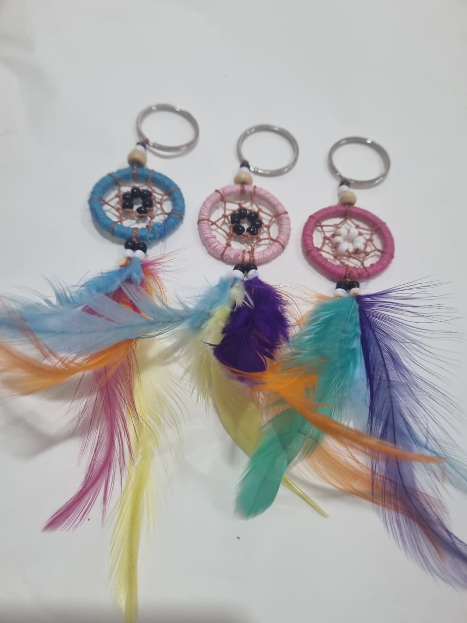Handcrafted dreamcatcher keychain with colorful feathers and cotton web