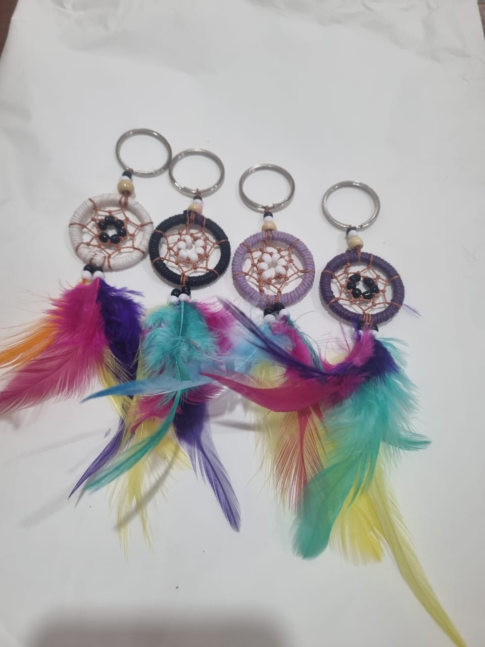 Handcrafted dreamcatcher keychain with colorful feathers and cotton web