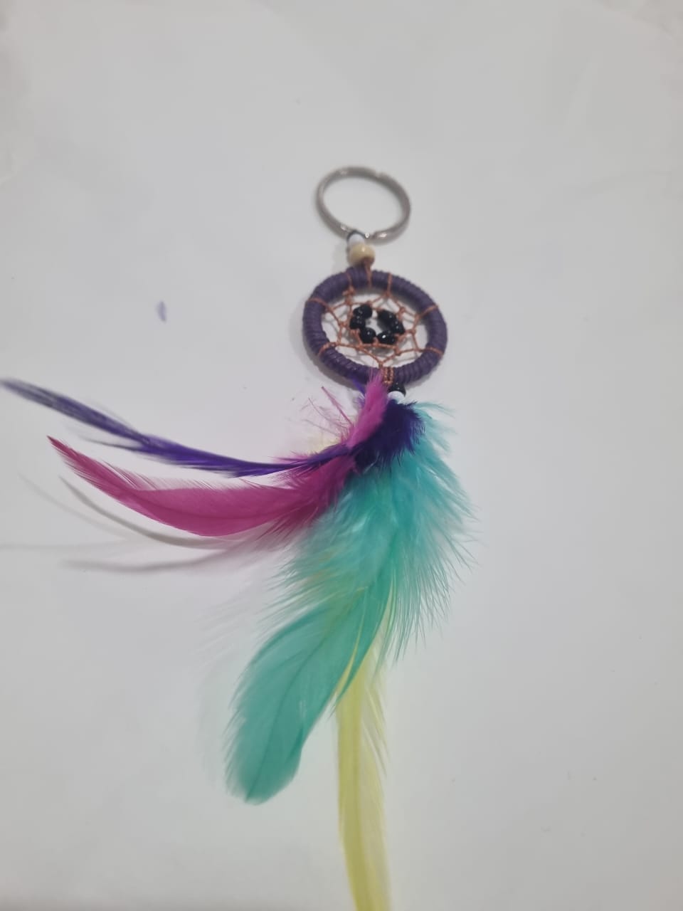Handcrafted dreamcatcher keychain with colorful feathers and cotton web