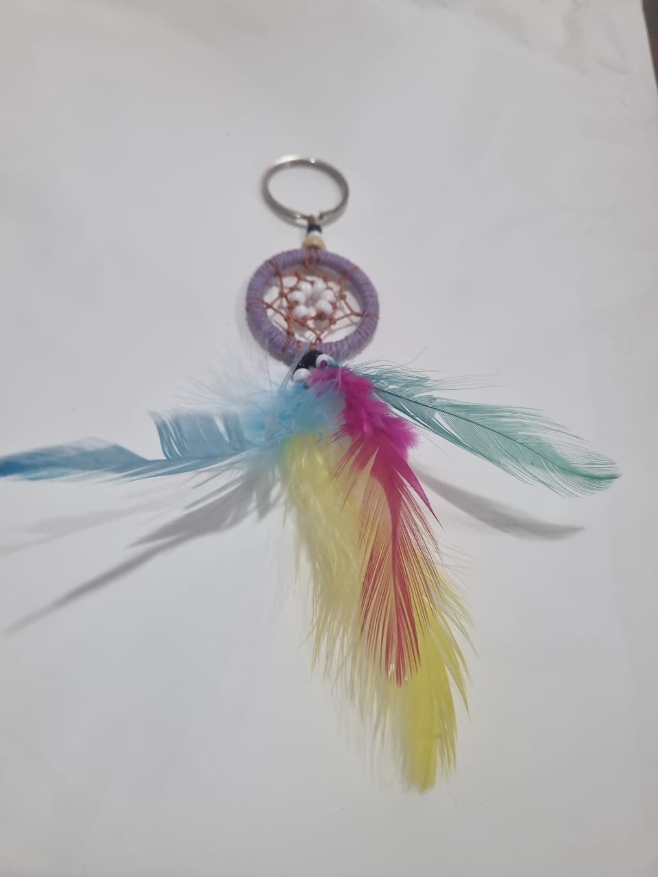 Handcrafted dreamcatcher keychain with colorful feathers and cotton web