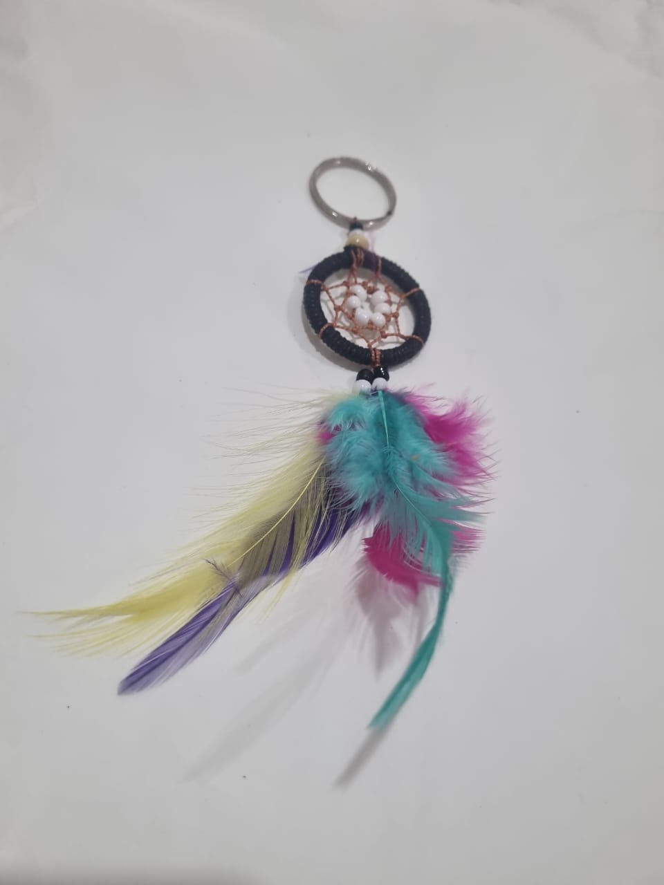 Handcrafted dreamcatcher keychain with colorful feathers and cotton web