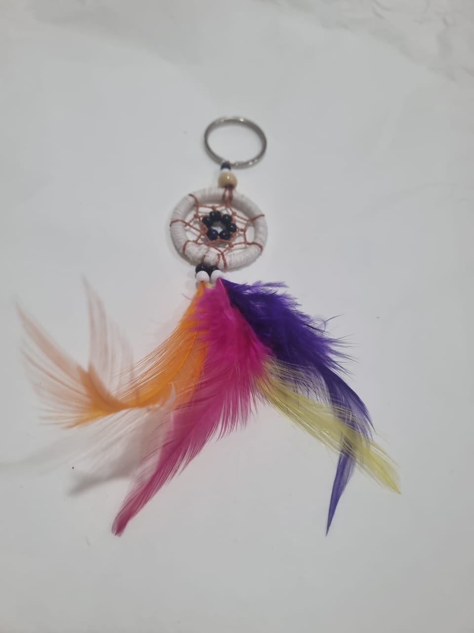 Handcrafted dreamcatcher keychain with colorful feathers and cotton web