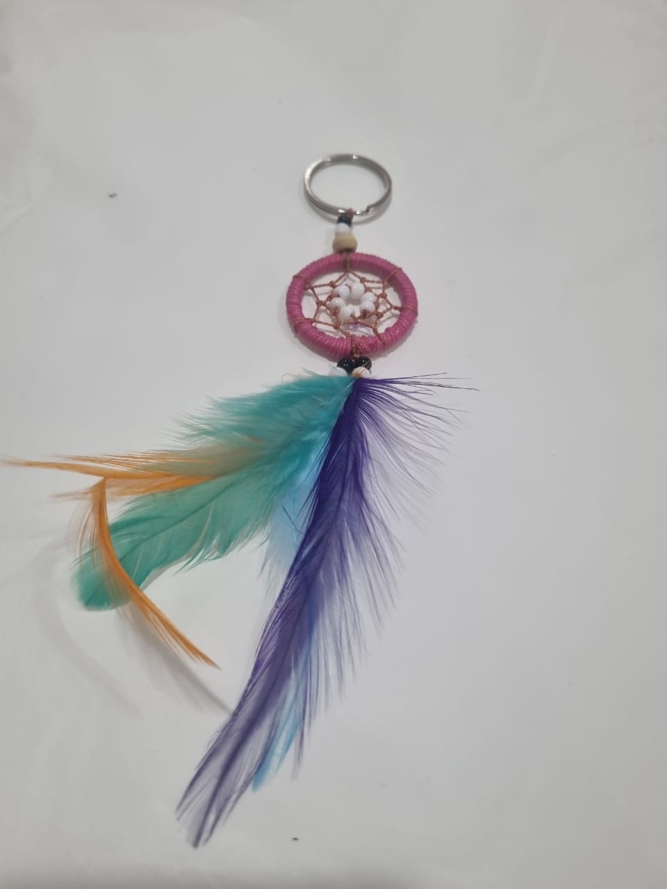 Handcrafted dreamcatcher keychain with colorful feathers and cotton web