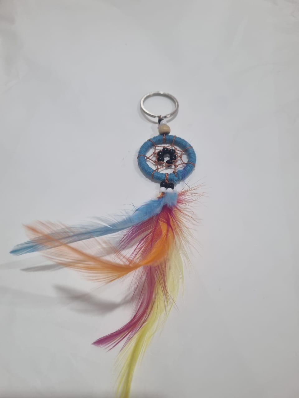 Handcrafted dreamcatcher keychain with colorful feathers and cotton web