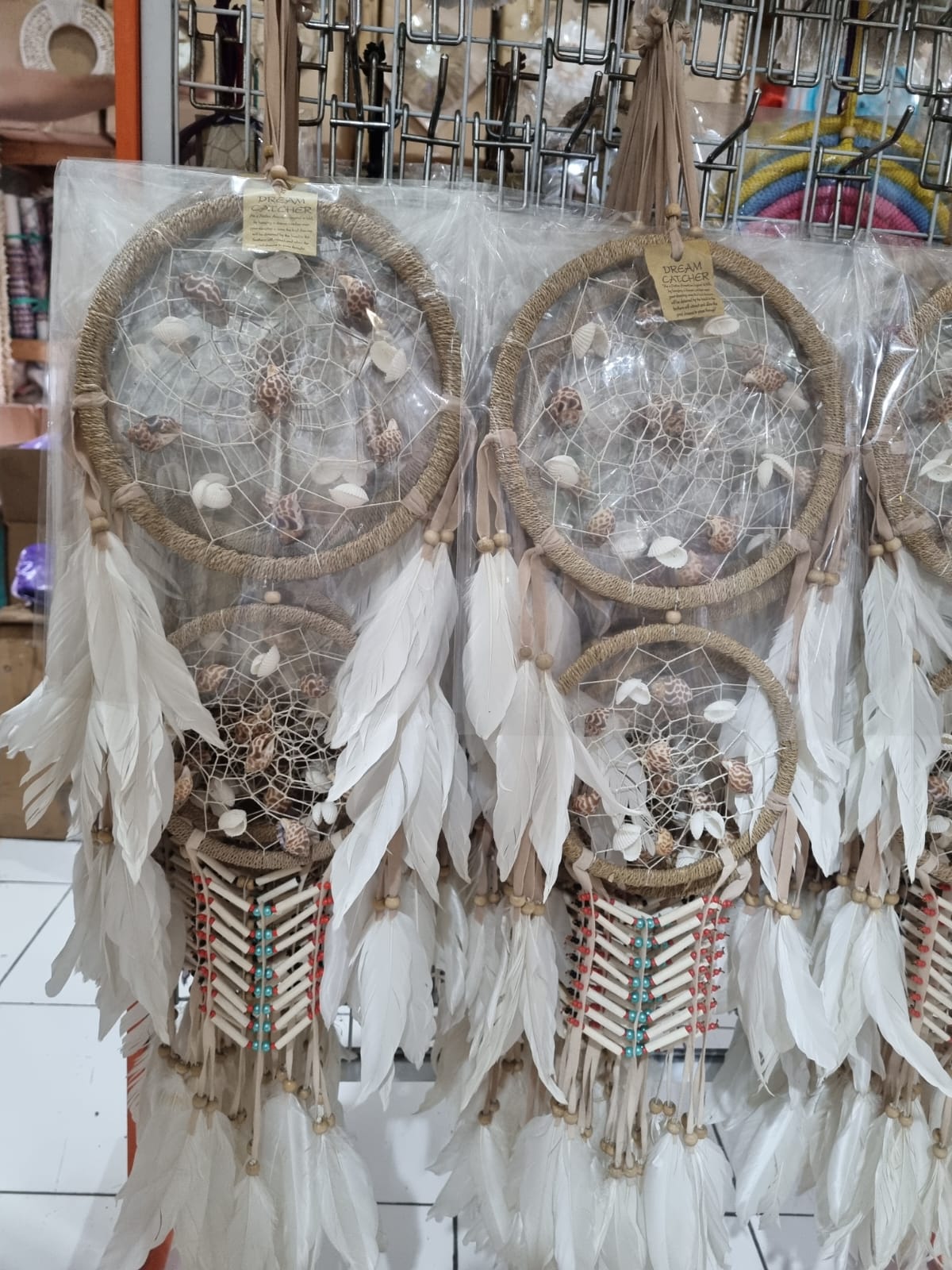 Double hoop dreamcatcher with agel fiber, white feathers, bone beads, and natural shells – perfect for boho decor