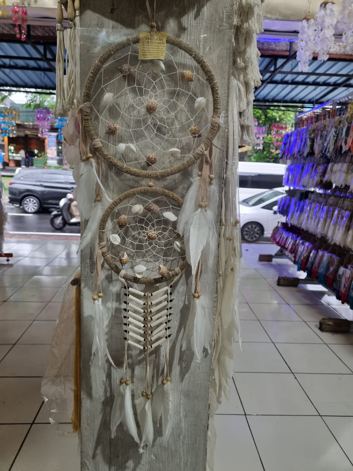 Double hoop dreamcatcher with agel fiber, white feathers, bone beads, and natural shells – perfect for boho decor