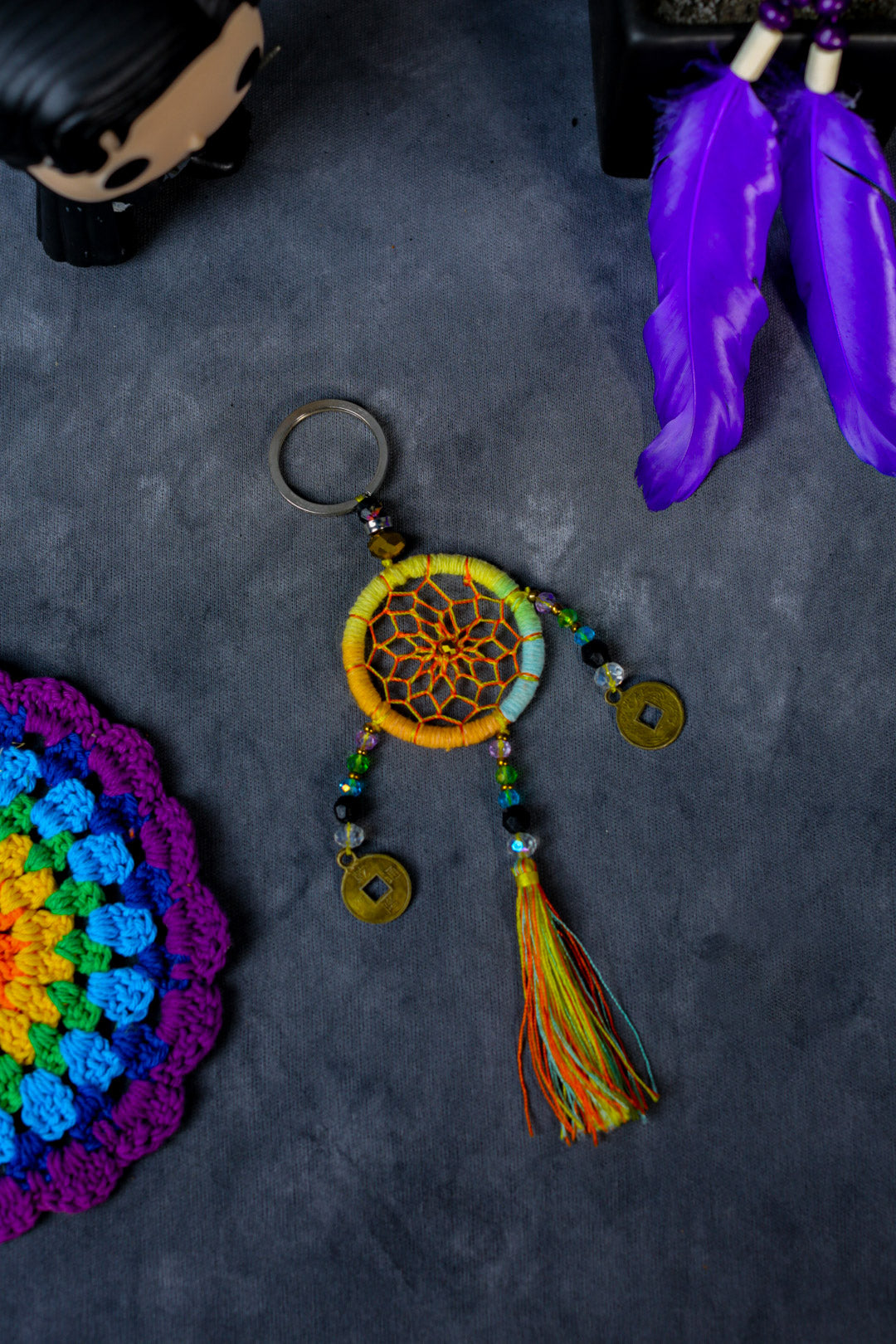 Hand-woven neon yellow dreamcatcher keychain with tassel, beads, and lucky coins.