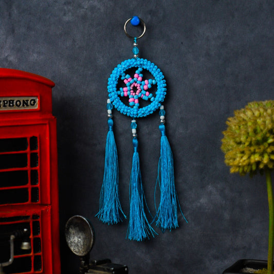 Turquoise beaded dreamcatcher keychain with triple tassels hanging on split ring.