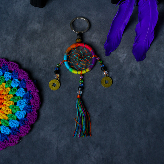Hand-woven rainbow dreamcatcher keychain with tassel, beads, and lucky coins.