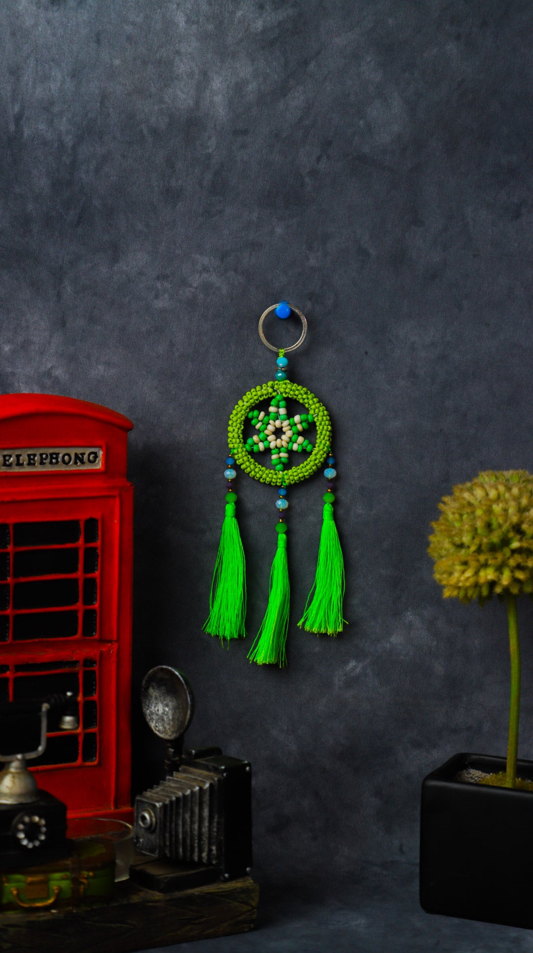 Turquoise beaded dreamcatcher keychain with triple tassels hanging on split ring.